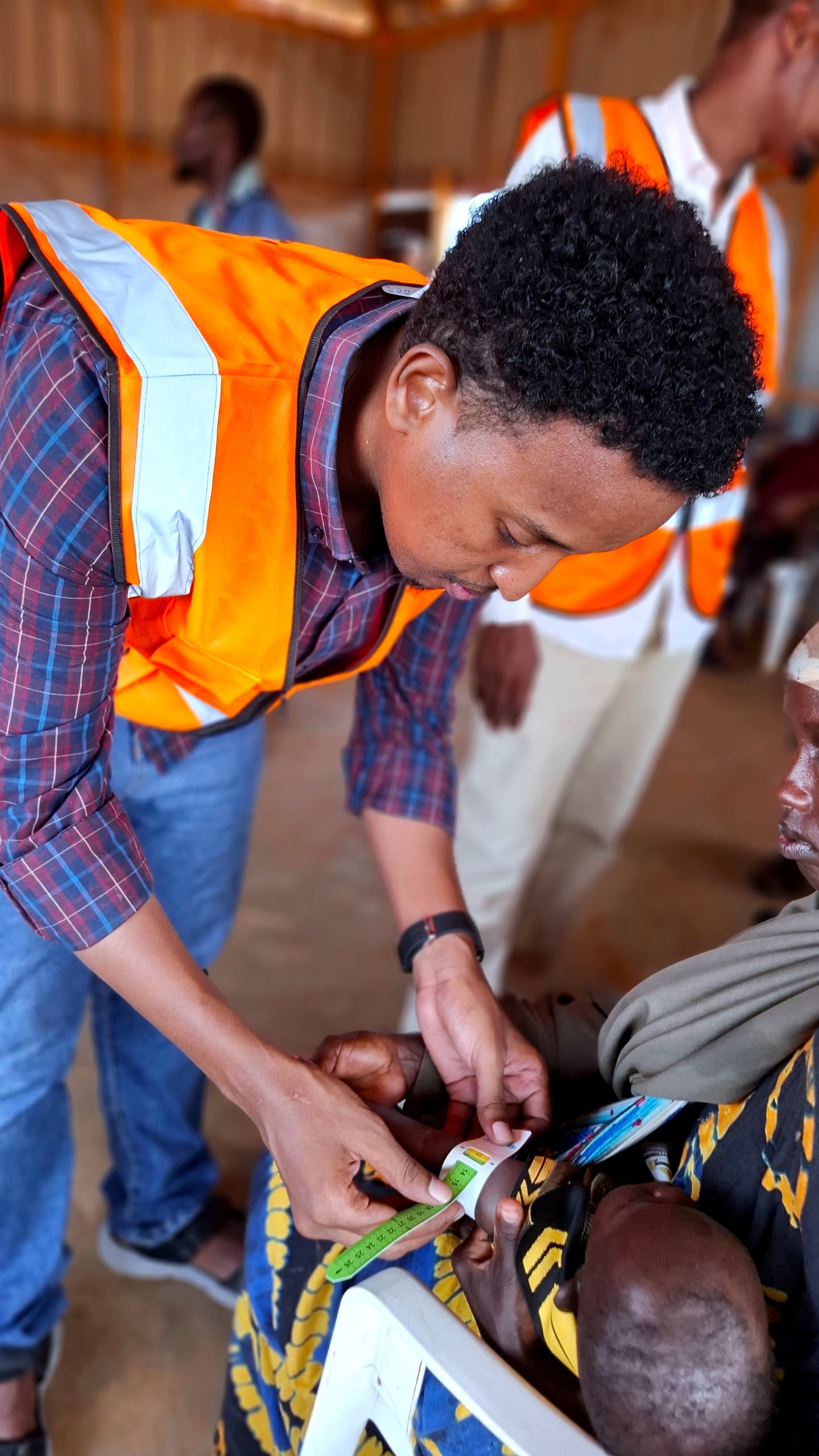 MHI staff conducting nutrition screening for a child